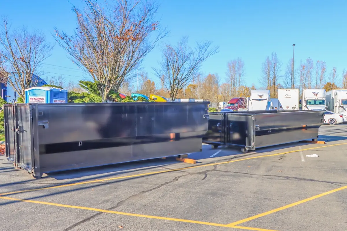 Professional dumpster rental service with roll-off container on residential driveway in Amity